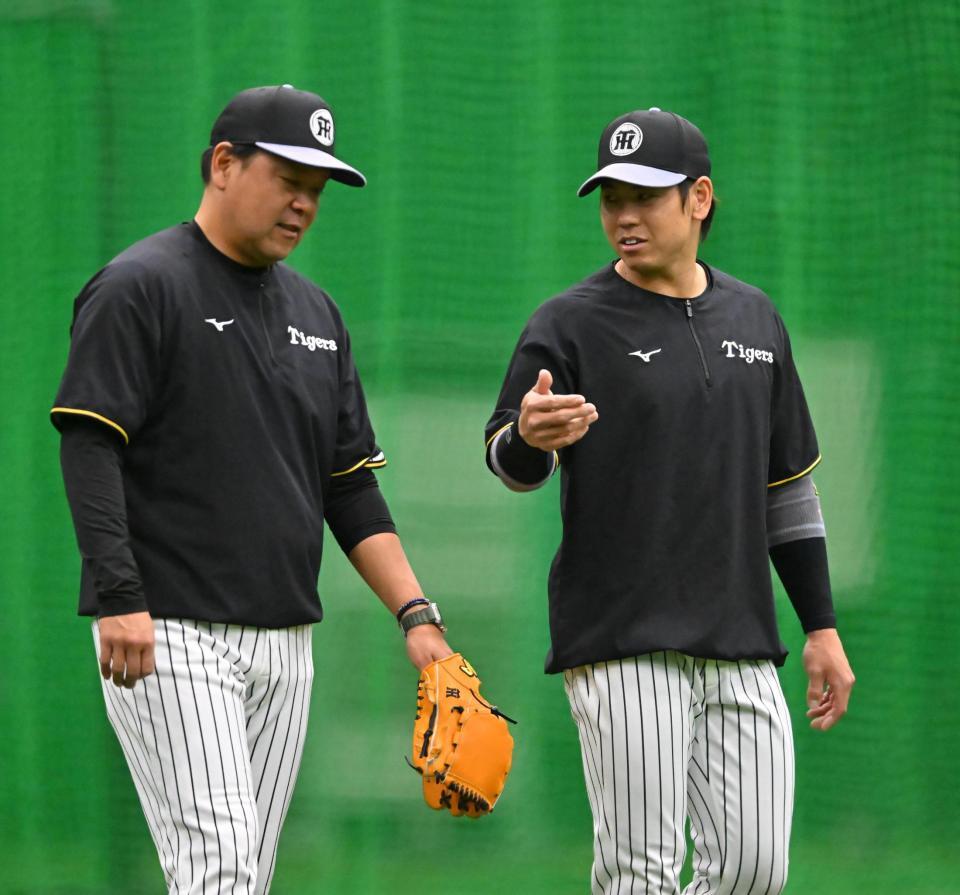 　野村コーチ（左）と話をする梅野（撮影・西田忠信）