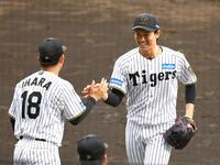 　６回、湯浅は満塁のピンチを高橋周を打ち取り笑顔でベンチに戻る（左は伊原）＝撮影・山口登