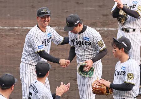 　１００セーブを挙げた岩崎（中央右）を祝福する藤川監督（撮影・立川洋一郎）