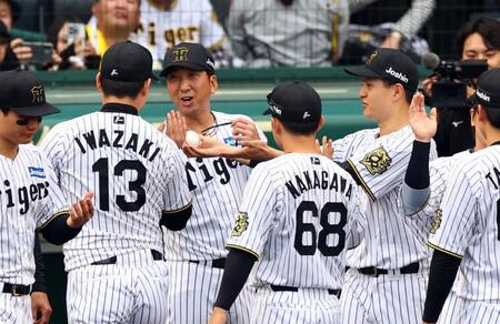 　岩崎からウイニングボールを渡されるも、岩崎に返そうとする大竹（中央右）＝撮影・山口登