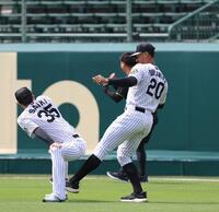 　ウオーミングアップする才木に左足を差し出す？デュプランティエ（右）＝撮影・北村雅宏