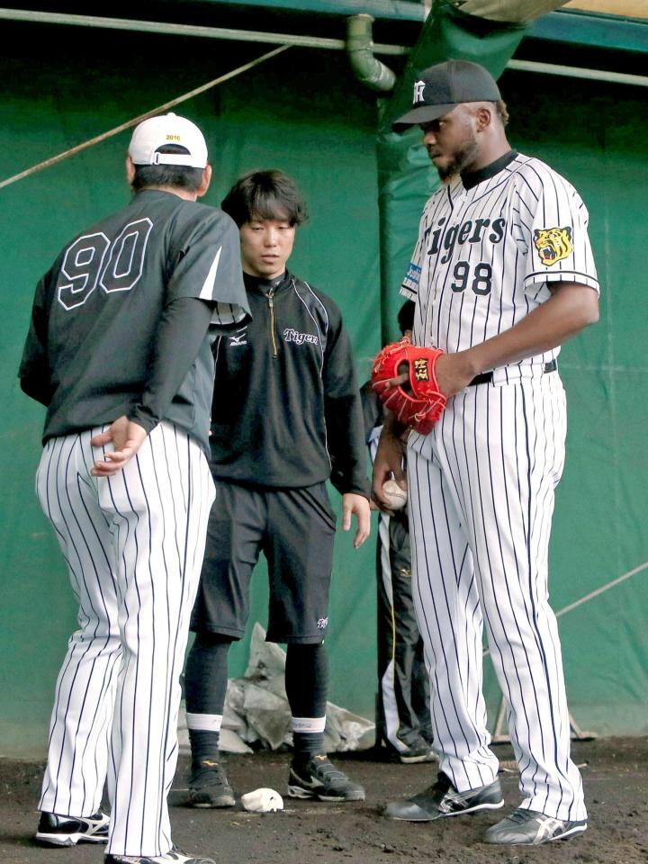 　香田コーチ（左）から指導を受けるドリス＝２０１６年、宜野座