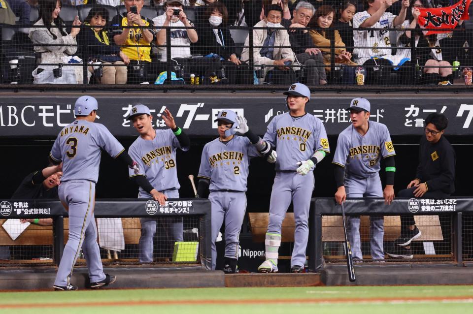 　６回、先制ソロを放った大山（左）を迎える阪神ナイン（撮影・中島達哉）