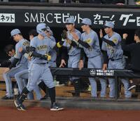 ４回、ソロを放ち、ナインに迎えられる佐藤輝（撮影・西岡正）