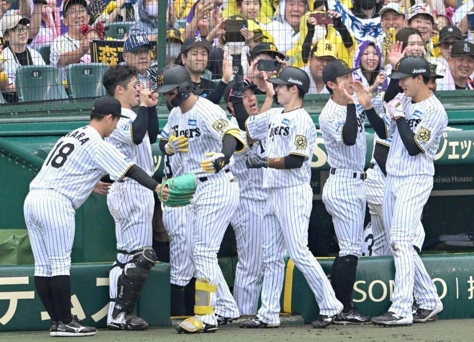 　３回、３ランを放った森下は伊原（左）に最敬礼で迎えられる（撮影・飯室逸平）