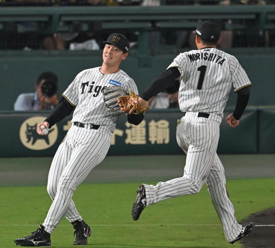 　６回、好リリーフを見せ、森下（１）とタッチを交わす木下（撮影・飯室逸平）