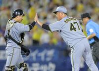 　最後を締め、梅野（左）とタッチを交わす桐敷（撮影・西岡正）