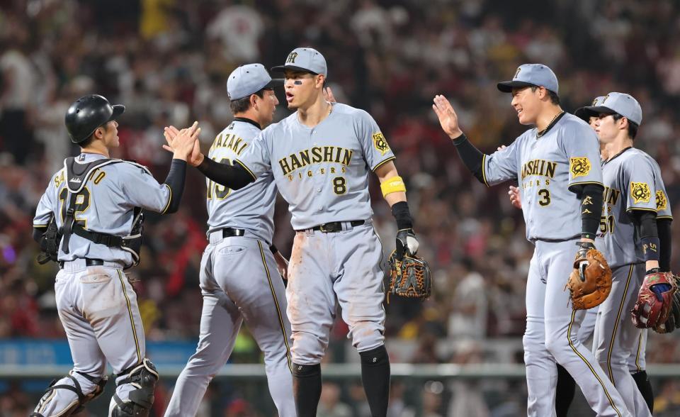 　勝利を手にし、タッチを交わす佐藤輝（撮影・市尻達拡）