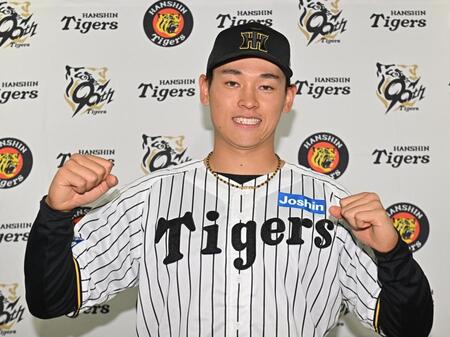 　支配下登録され、ポーズを決める早川（撮影・西田忠信）