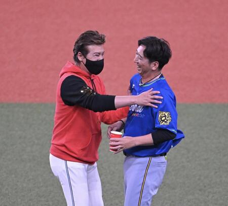 　笑顔であいさつを交わす新庄監督（左）と藤川監督