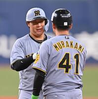 　２回、中前打を放ち村上（手前）とタッチを交わす大山（撮影・西田忠信）