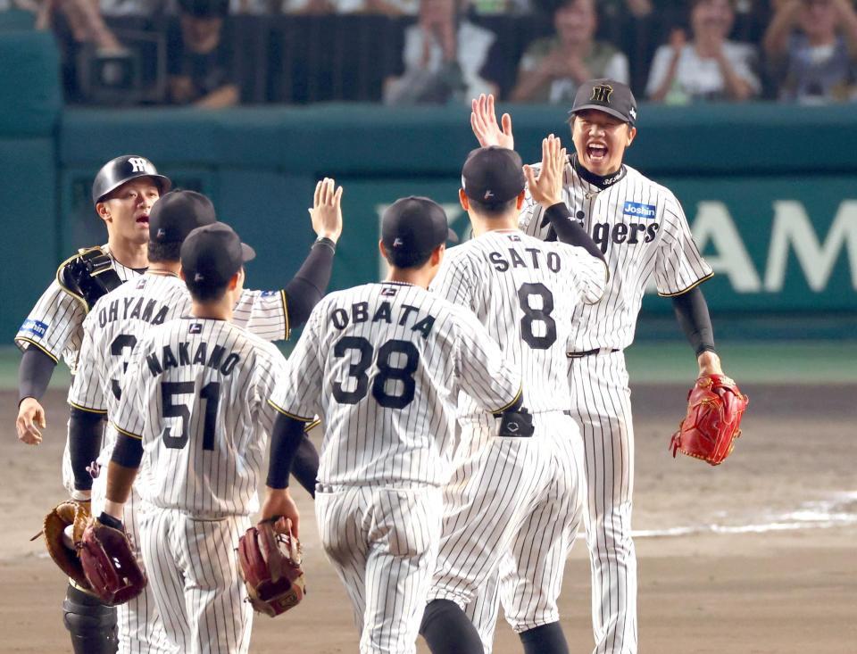　完封勝利を飾り、佐藤輝（８）らナインと喜びを分かち合う才木（右）＝撮影・山口登