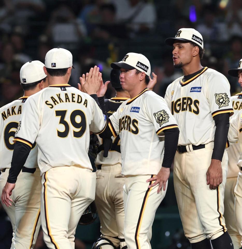 　チームが快勝し、栄枝（３９）とタッチを交わす村上（中央）＝撮影・北村雅宏