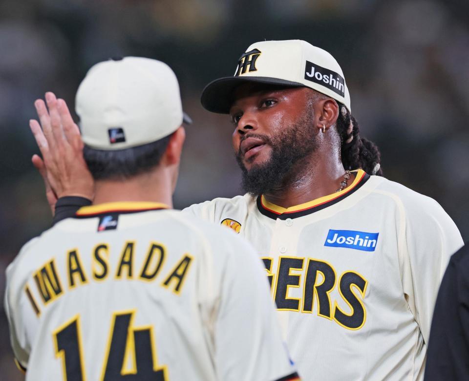 　９回表に登板して無失点に抑え、ナインとタッチを交わすドリス（撮影・立川洋一郎）