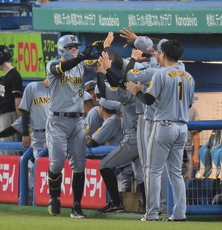 　４回、右越えソロを放ち、ナインに迎えられる佐藤輝（撮影・伊藤笙子）