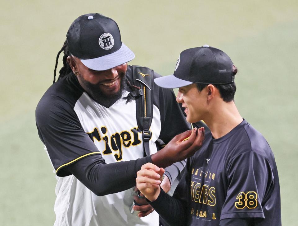 　小幡（右）に「ヒゲを生やせよ」とばかりにイジリ返すドリス（撮影・立川洋一郎）