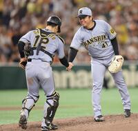 　完封勝利で坂本（左）と握手する村上（撮影・西岡正）