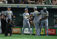 　岩崎と握手を交わす石井（撮影・金田祐二）