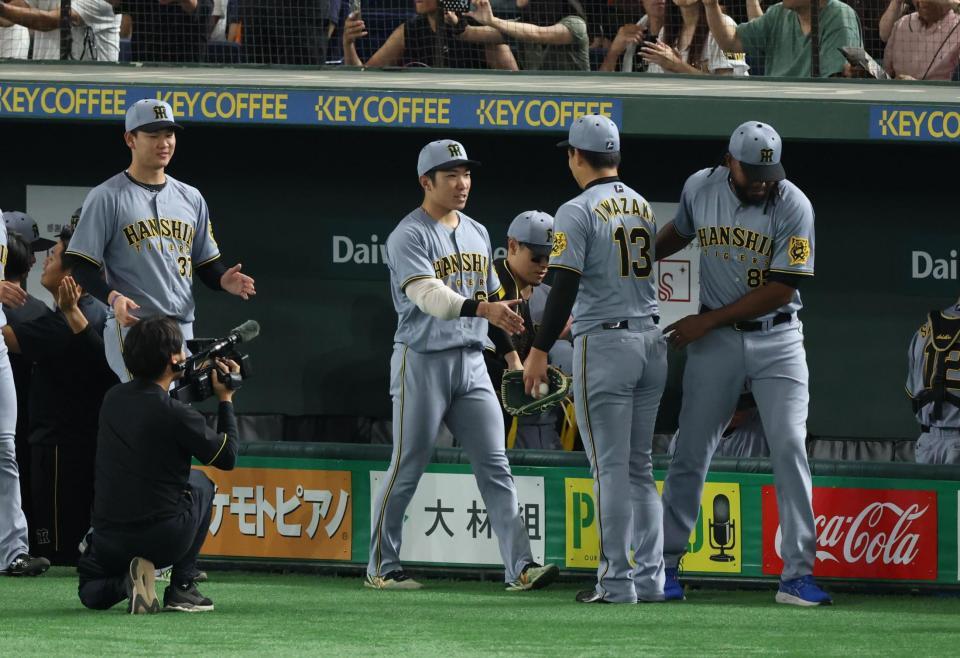 　岩崎と握手を交わす石井（撮影・金田祐二）