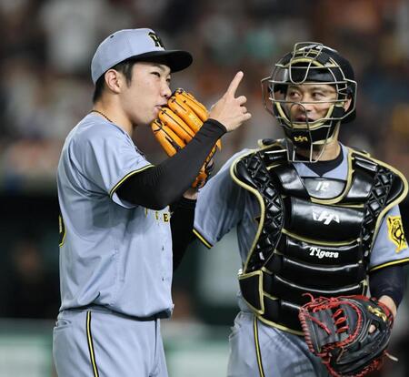 　８回を無失点に抑えた石井は坂本と話しながらベンチへ戻る（撮影・田中太一）