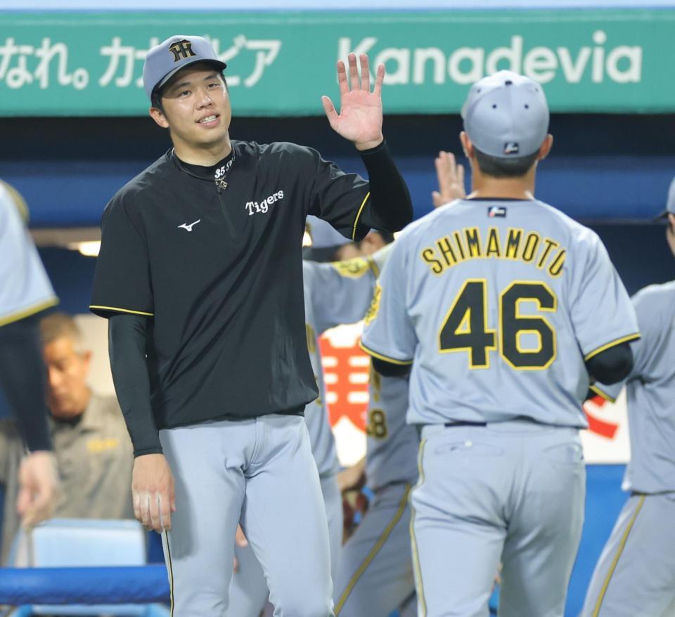 　８回、リリーフした島本（右）を迎える才木（撮影・西岡正）