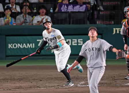 　８回、左翼スタンドへ２者連続となるソロを放つ佐藤輝（撮影・立川洋一郎）