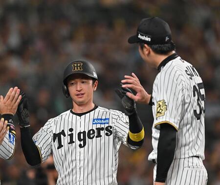 　３回、森下の先制打で生還し、才木（右）とタッチを交わす近本（撮影・西田忠信）