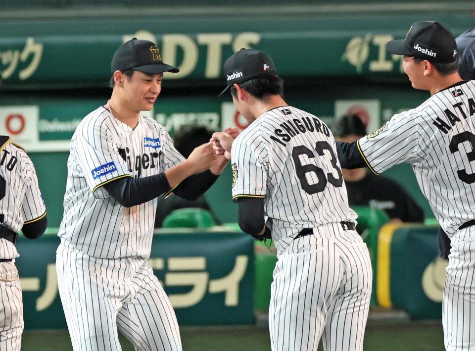 　最後を締めくくった石黒（６３）とタッチを交わす大竹＝５日