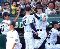 　３回、２ランを放ちナインに迎えられる佐藤輝（撮影・山口登）