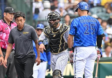 　４回、手当てのためベンチ裏へ向かう梅野（中央）＝撮影・西田忠信