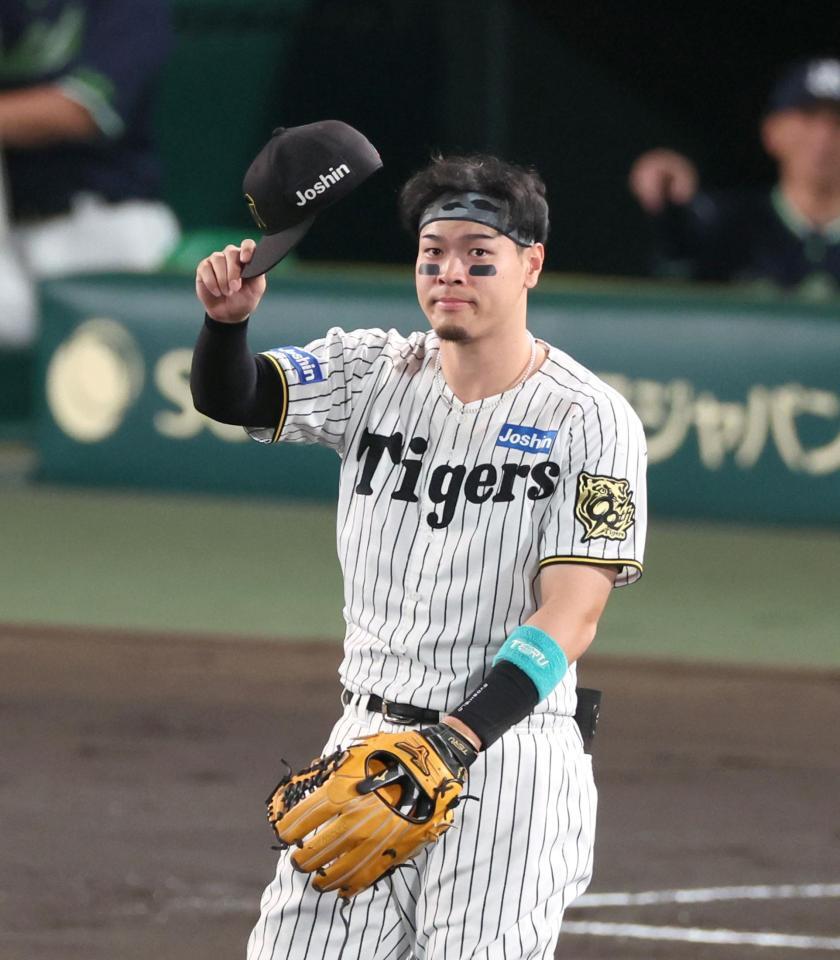 　２回表の守備に就き、スタンからの「テルコール」に応える佐藤輝（撮影・立川洋一郎）