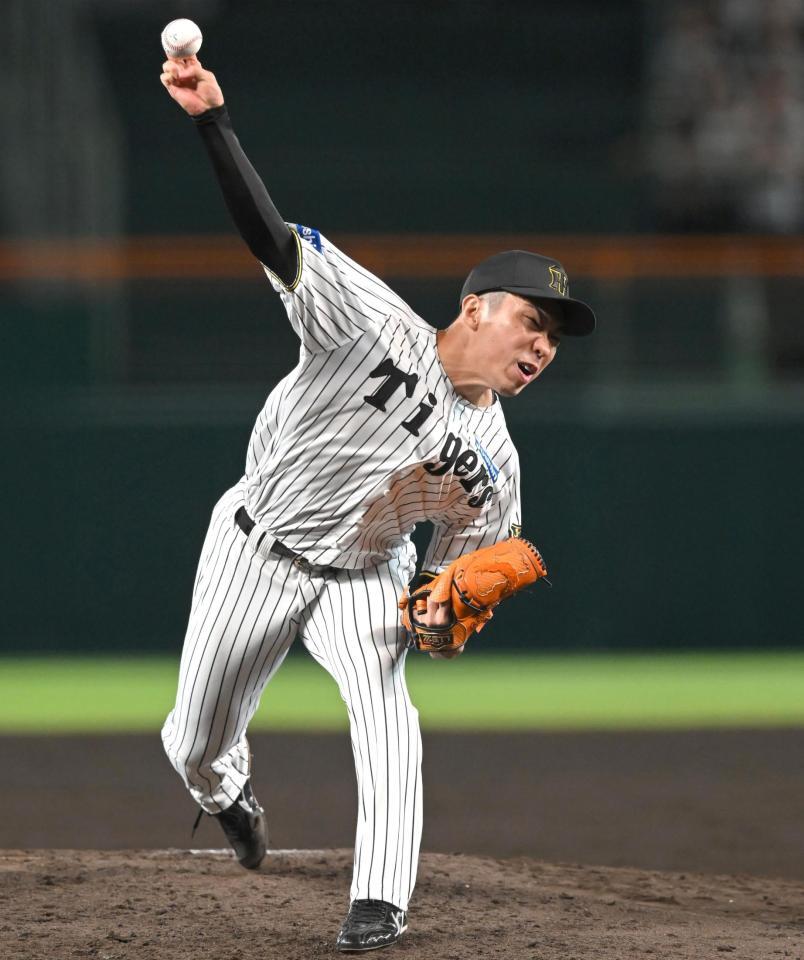 　７回、気迫の投球を見せる石井（撮影・飯室逸平）