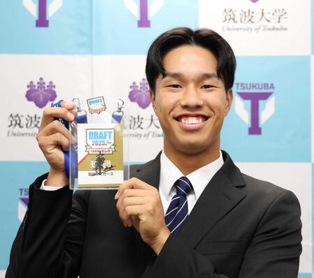 　藤川監督のサイン入りドラフト会議パスを手にする岡城（撮影・佐々木彰尚）