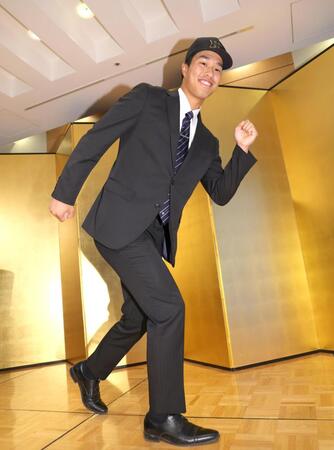 　仮契約交渉を終え、笑顔で走るポーズを見せるドラフト３位指名の岡城快生（撮影・吉澤敬太）