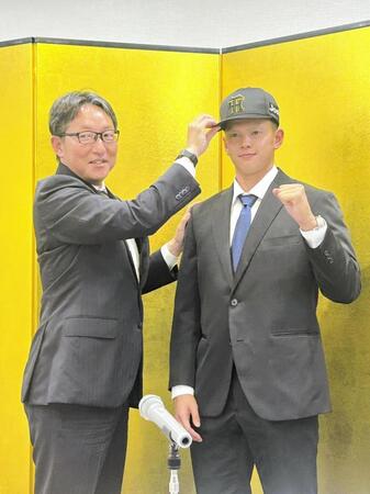 　吉野スカウト（左）に帽子をかぶせてもらう能登（右）