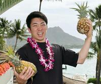 　パイナップルを持ち上げる石井（撮影・田中太一）