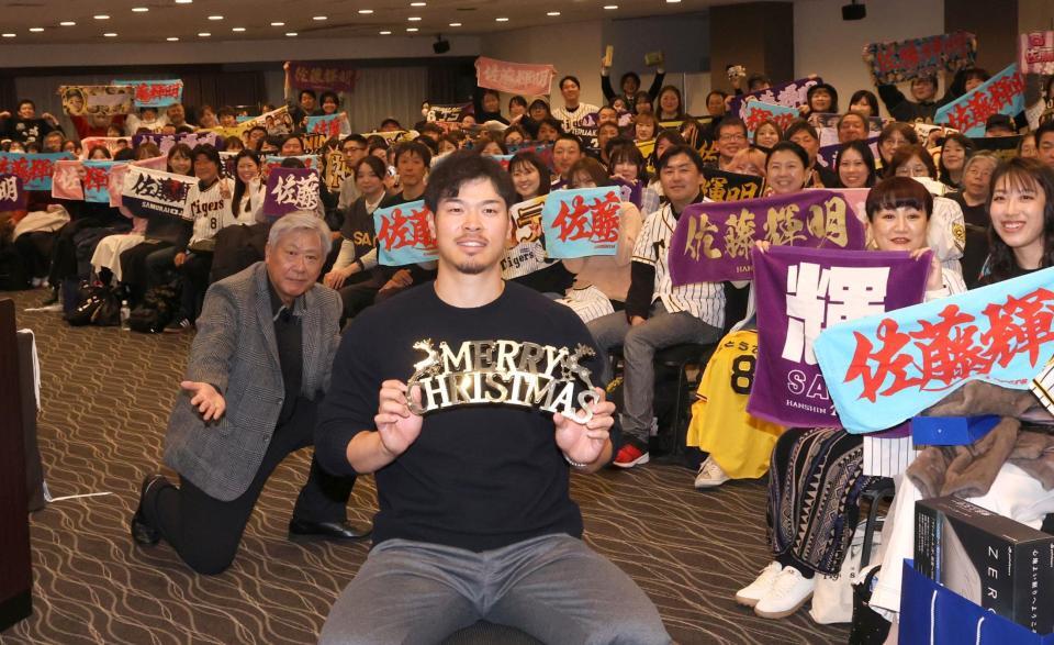 　ファンと記念写真に納まる佐藤輝（中央）＝撮影・北村雅宏