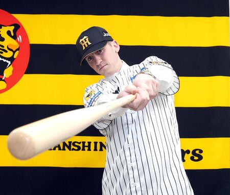 入団会見でポーズを決めるキャム・ディベイニー（撮影・山口登）