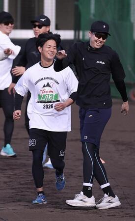 笑顔でウォーミングアップする高橋（左）＝撮影・西田忠信