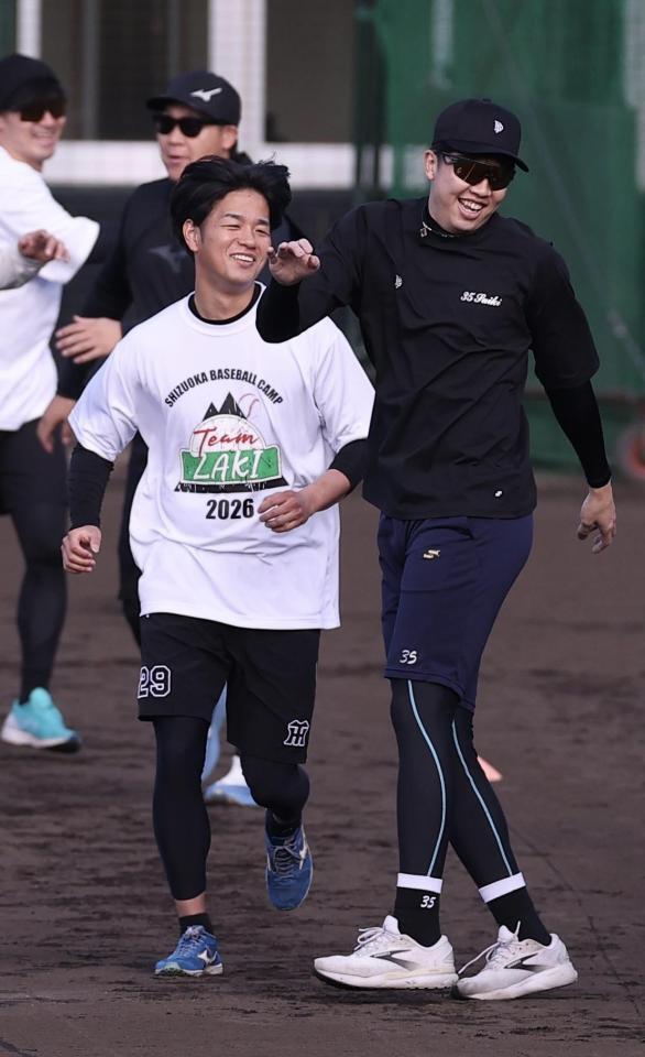 笑顔でウォーミングアップする高橋（左）＝撮影・西田忠信