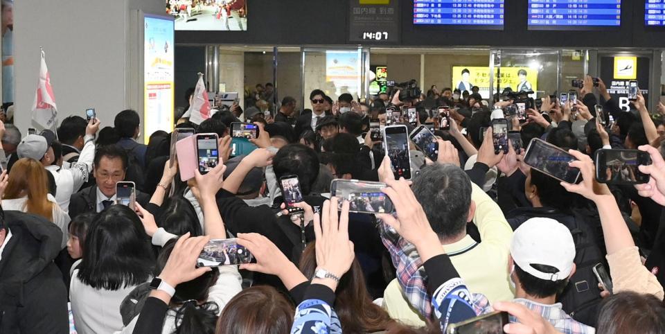ファンが殺到する中、沖縄入りする佐藤輝（中央奥）＝撮影・飯室逸平