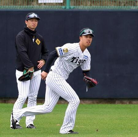 ノックの打球を追う岡城（左は近本）＝撮影・山口登