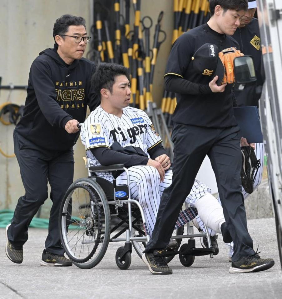 車椅子で球場を後にする石井