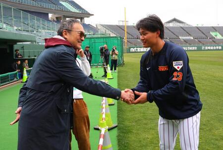 【写真】目立ちすぎ！！坂本はブルペンで真っ赤なフルフェイスヘルメット着用　背後には大物俳優の姿が