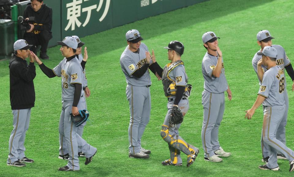 阪神・坂本誠志郎を出迎える藤川球児監督＝東京ドーム（撮影・佐々木彰尚）