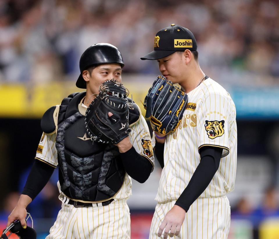 ８回を投げ終え、坂本（左）とベンチに戻る及川（撮影・西田忠信）