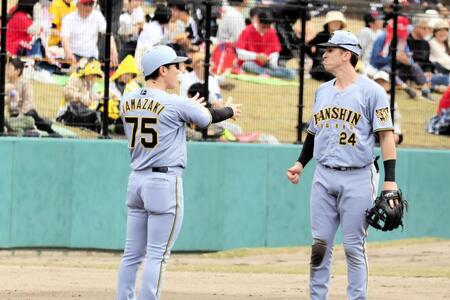 ２回表攻撃終了後、山崎憲晴２軍内野守備走塁コーチ（左）と話すディベイニー