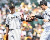 初回を三者凡退に抑え、小幡（右）とタッチを交わす大竹（撮影・西田忠信）