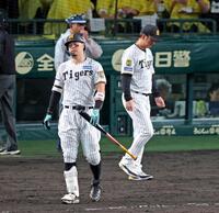 ９回、空振り三振に倒れ肩を落として引き揚げる佐藤輝。右は藤川監督（撮影・立川洋一郎）