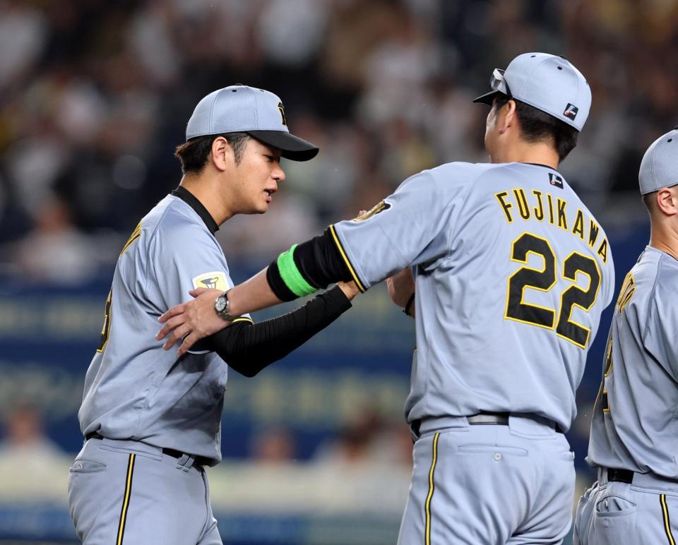 ６勝目を挙げた高橋（左）は藤川監督から祝福される（撮影・山口登）